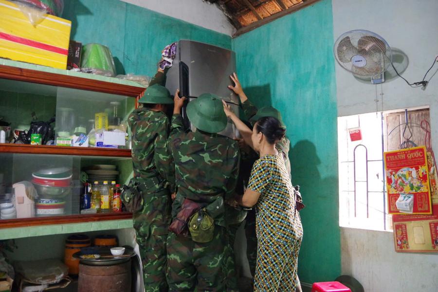 Giúp dân kê cao vật dụng, tài sản trước khi bão đổ bộ. Ảnh: Huyền Trang ke-cao-vat-dung.jpg